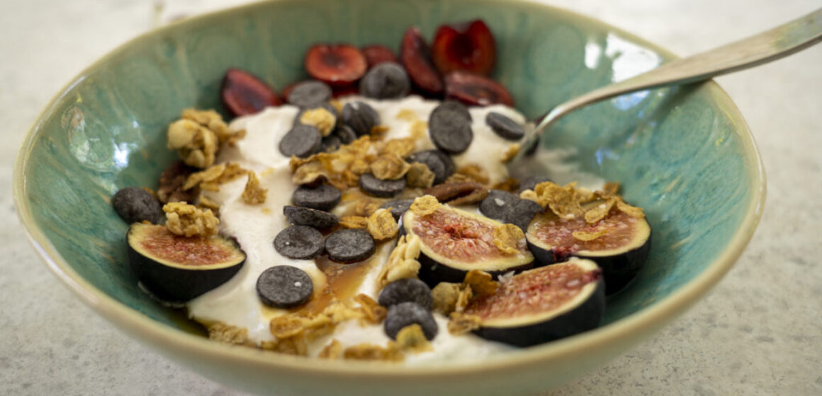 Yogurt Bowl with fruit, granola, chocolate chips, honey, and kosher salt