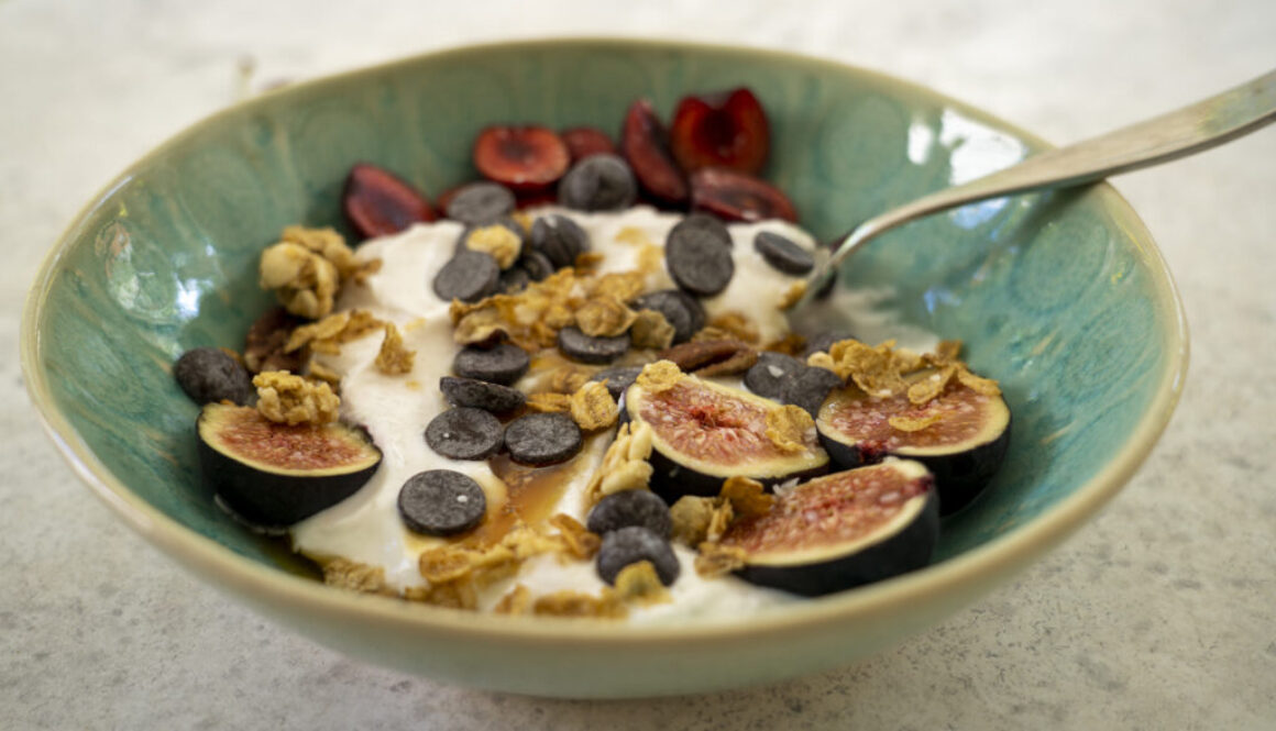 Yogurt Bowl with fruit, granola, chocolate chips, honey, and kosher salt